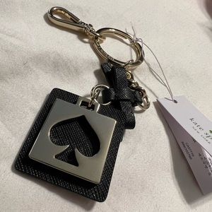 Black and gold cut out Kate Spade key fob / bag charm
